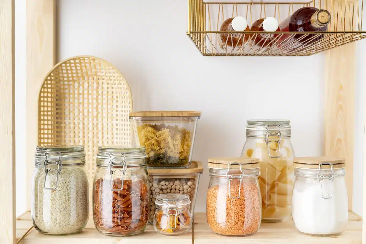 Glass food storage containers with lids arranged together on a kitchen surface