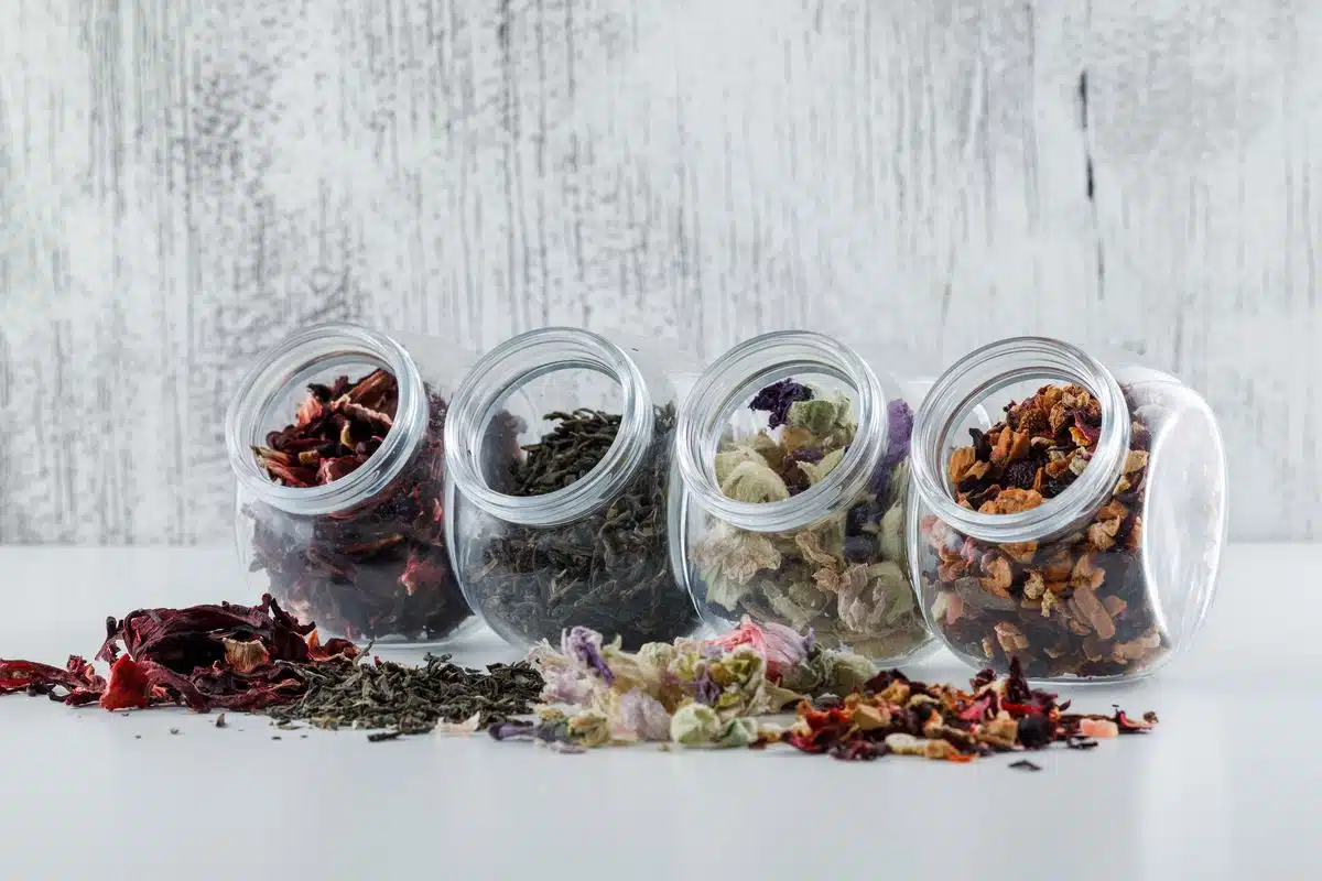Assorted dried herbs and ground spices in labelled jars