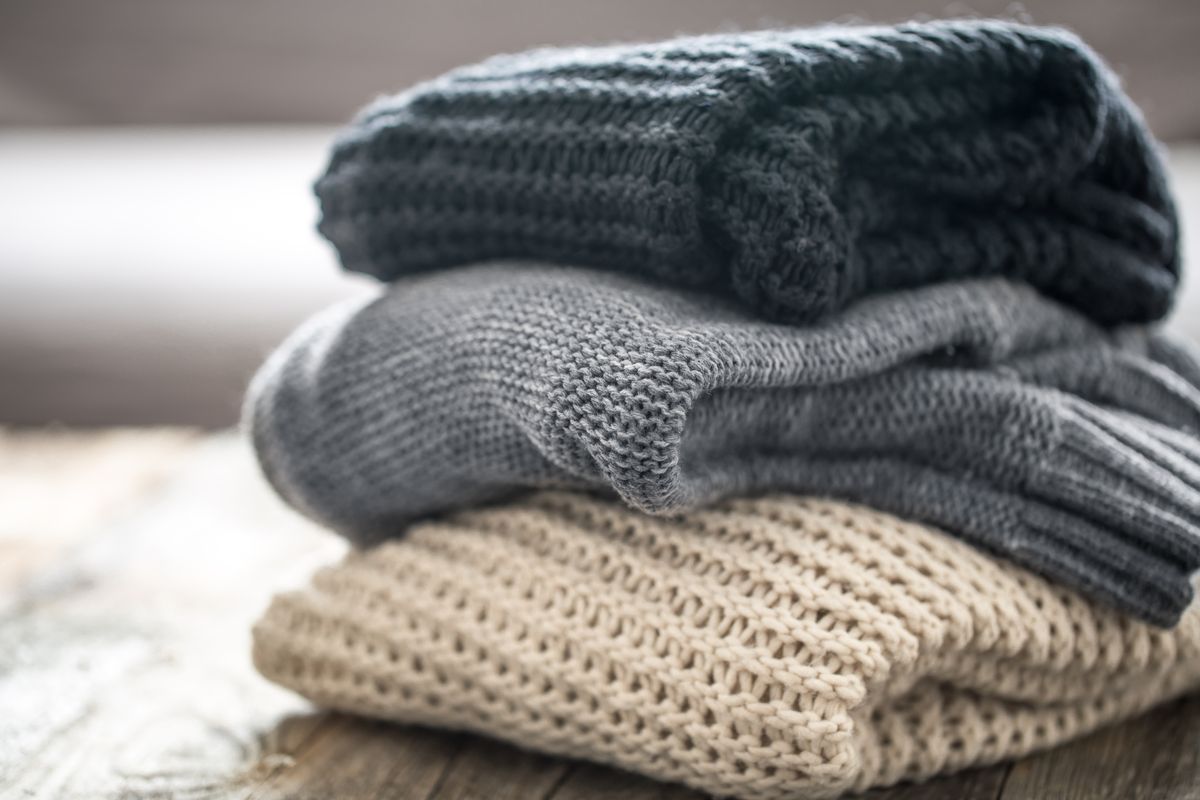 Stack of neatly folded knitted wool sweaters