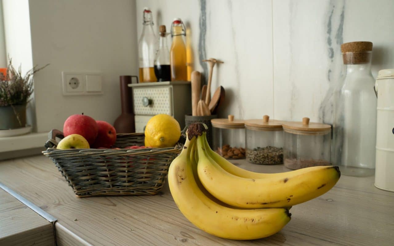 Basket of fresh fruit left out on a kitchen table