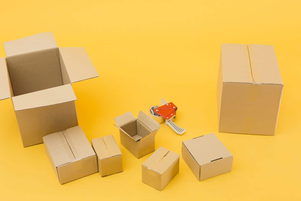 Several unopened cardboard delivery boxes gathered together on a floor, seen from above